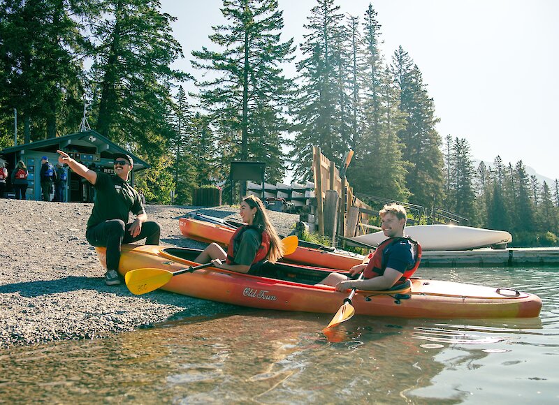 Friendly staff helping kayakers get ready for the river