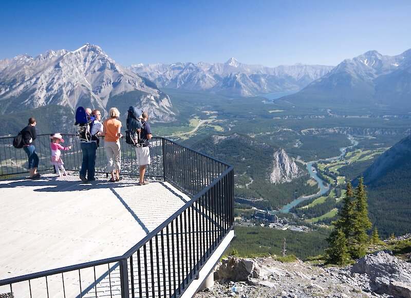 People checking out the view of the Rocky Mountains on the Banff gondola viewing deck