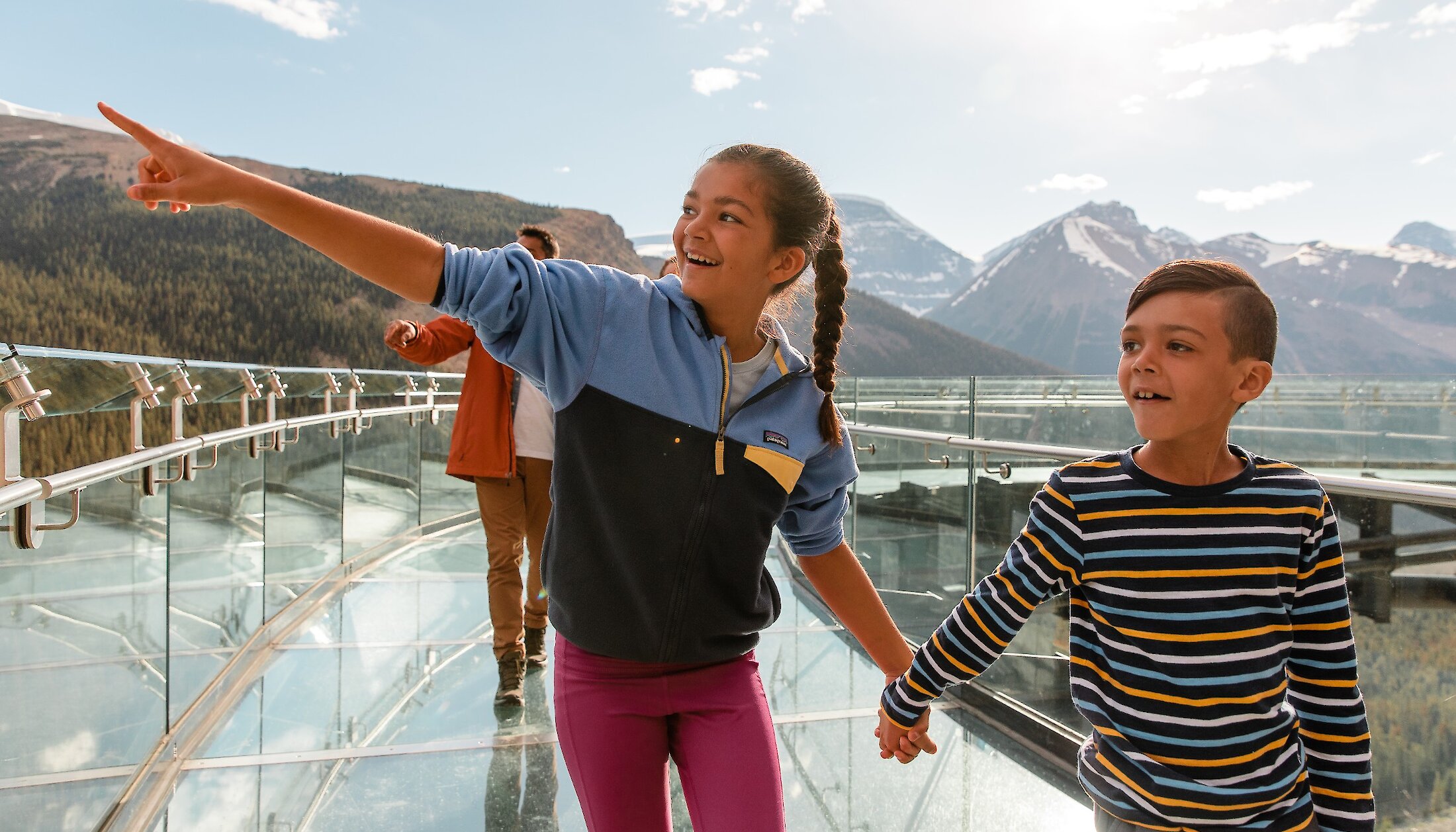 Two children looking out on the beautiful Mountain views at the glass bottom skybridge