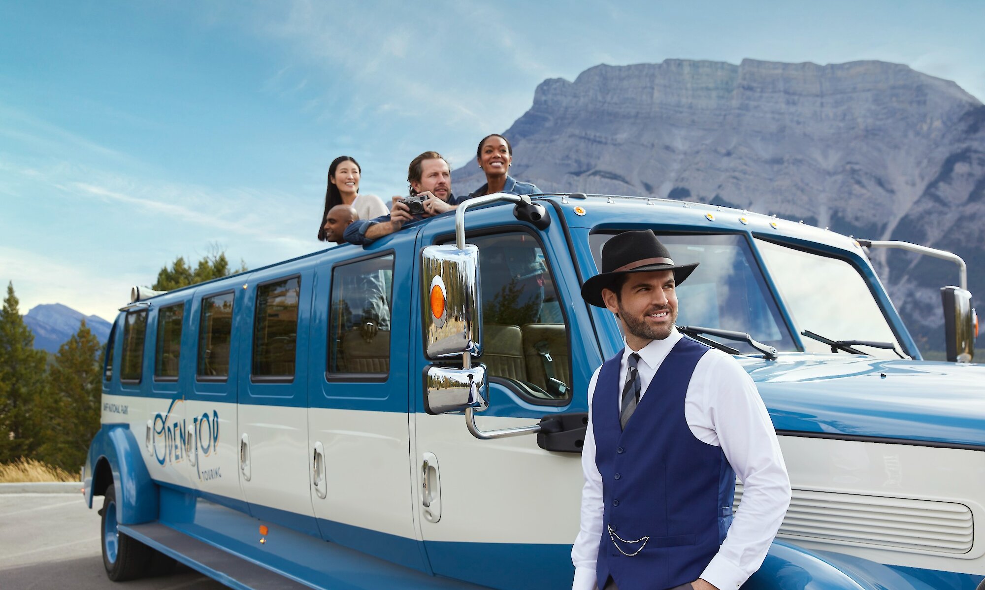 Guide and guests on open top tour in Banff