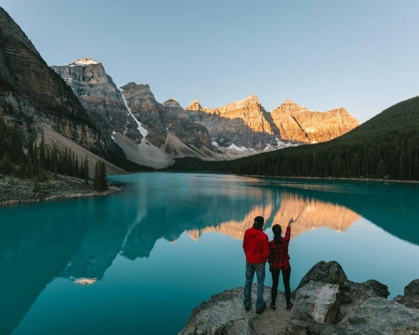 A couple enjoying the sunset at Moraine Lake in Banff