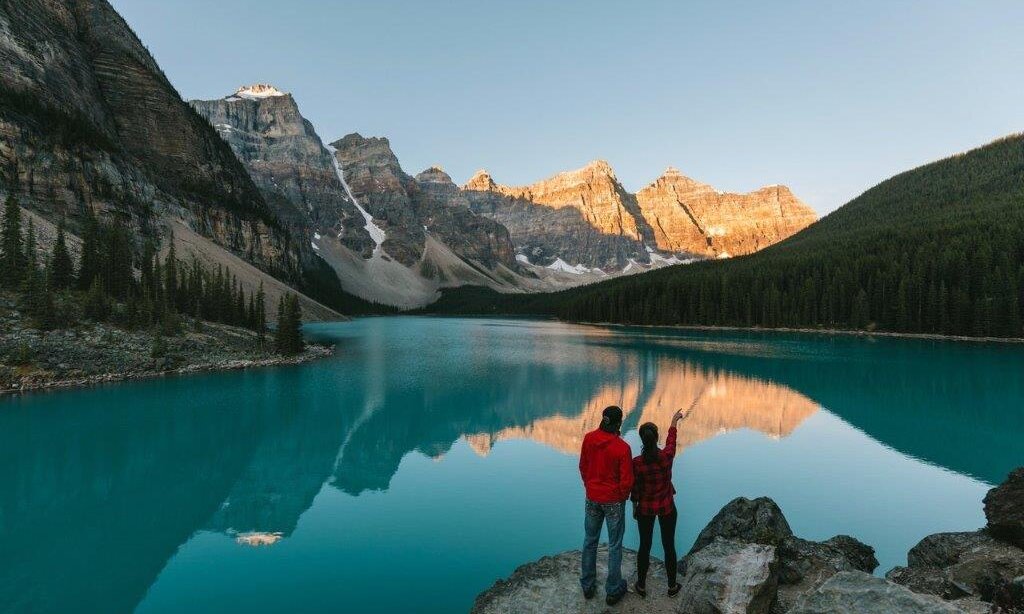 A couple enjoying the sunset at Moraine Lake in Banff
