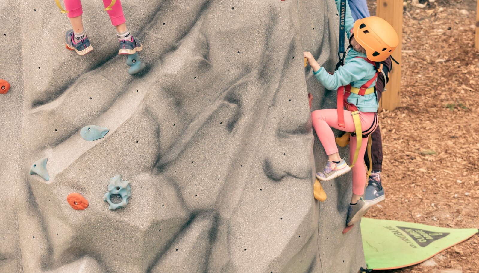 Kids enjoying the climbing wall at the Golden Skybridge