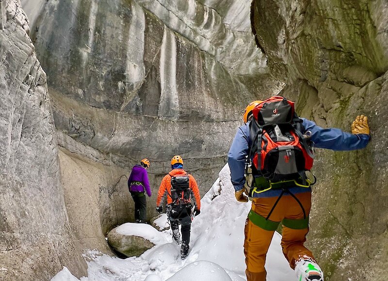 A guided group walking through the canyon in winter