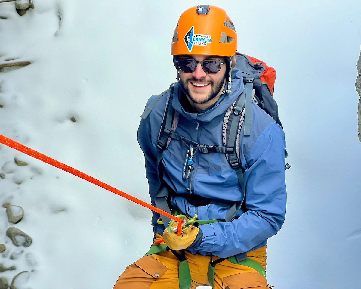A man rapelling down an icefall in Banff