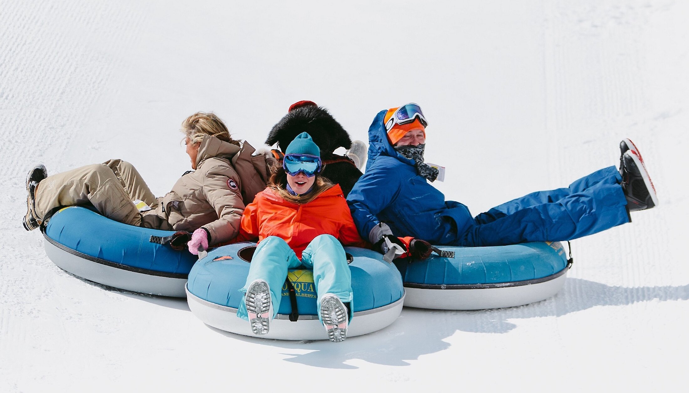 Family of four snow tubing at Mount Norquay Ski Resort