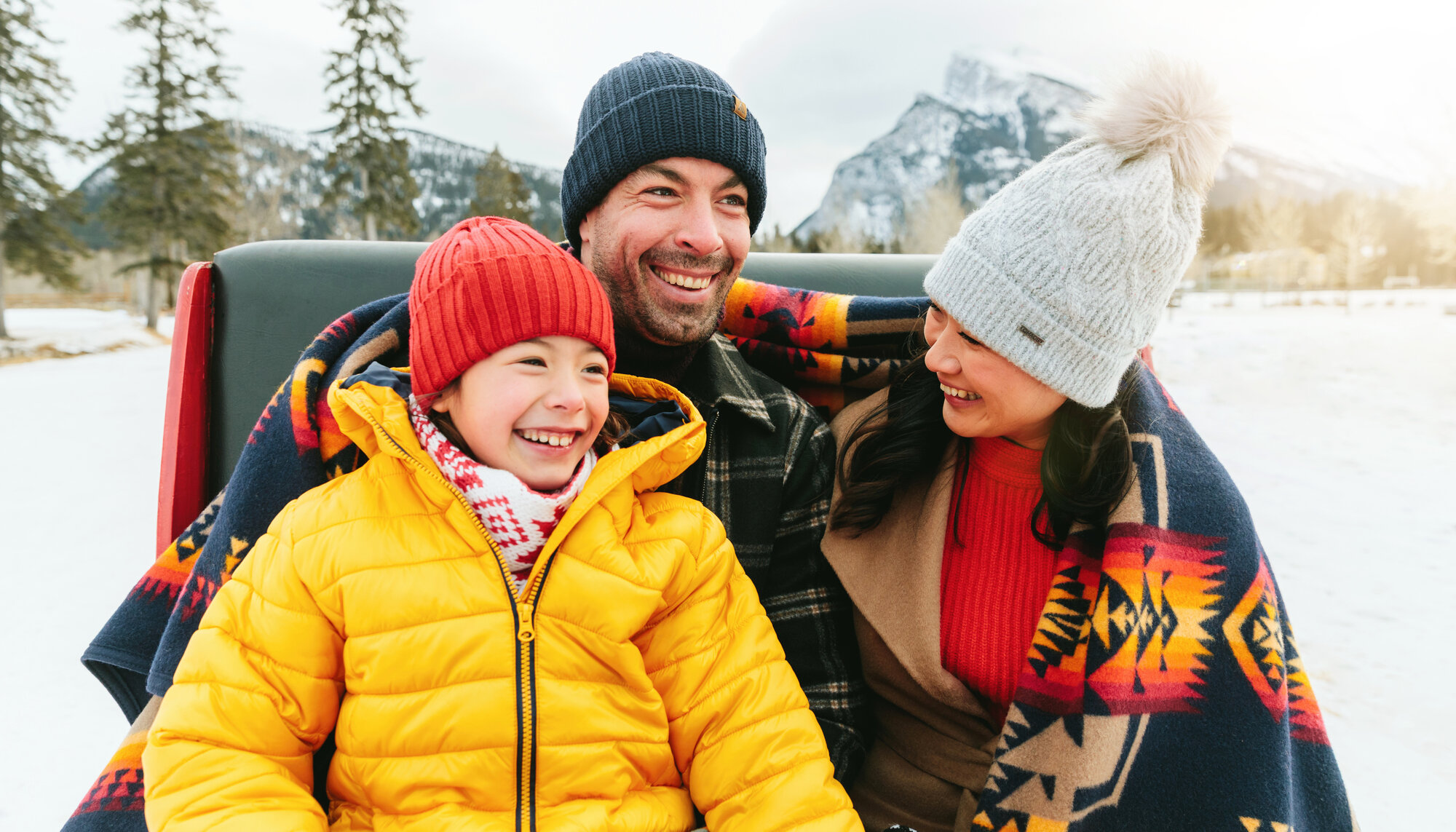 Family enjoying a sleigh ride at the Warner Stables in Banff