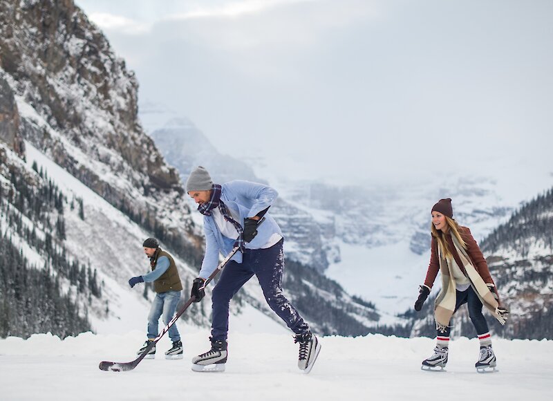 A group of friends playing ice hockey on Lake Louise