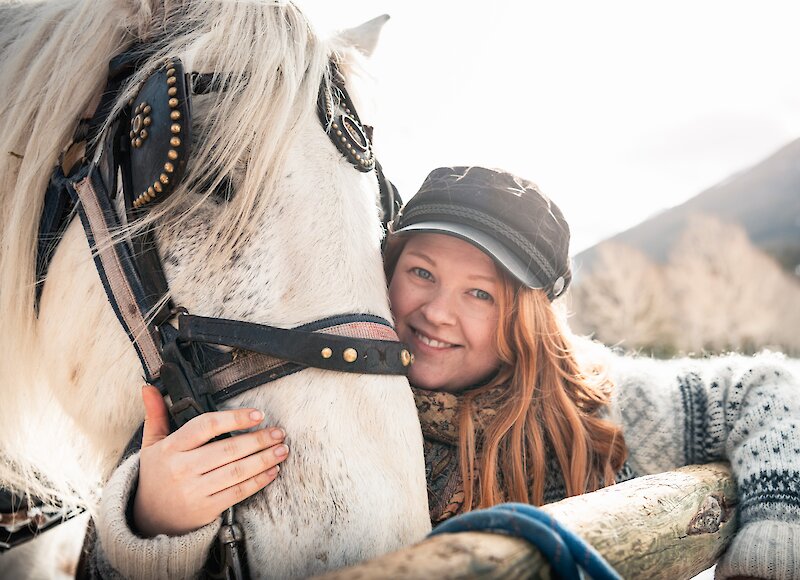 Enjoying snuggles from our friendly sleigh ride horses